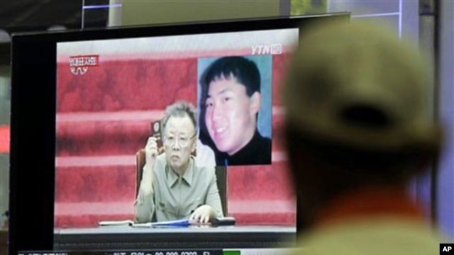 A South Korean man in Seoul watches a TV news program showing North Korean leader Kim Jong Il as he appointed youngest son, Kim Jong Un - shown in portrait at top right - as an army general in an apparent sign he is being groomed as country's next leader,