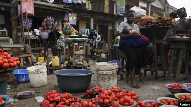 A woman waits for customer at a local food market, in Nigeria's commercial capital Lagos, January 16, 2012. 