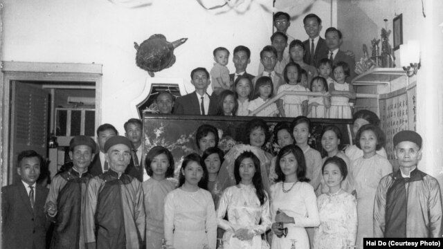 FILE - A family photo from the wedding of Hai Do's aunt, Pham Thi Nhung, center. Do's grandfather, Pham Dinh Lieu, is in front, at the far right. Do's mother, Pham Thi Loc, is to his right, in front. Hai Do is at the top of the photo, wearing glasses.