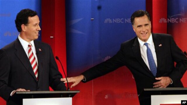 Republican presidential candidates former Massachusetts Gov. Mitt Romney, right, reaches out to former Pennsylvania Sen. Rick Santorum during a Republican presidential debate Monday Jan. 23, 2012, at the University of South Florida in Tampa, Fla.