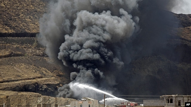 Firefighters battle a huge fire after several explosions were set off at the army's First Armored Division headquarters in Sanaa, Yemen, Oct. 18. 2012. 