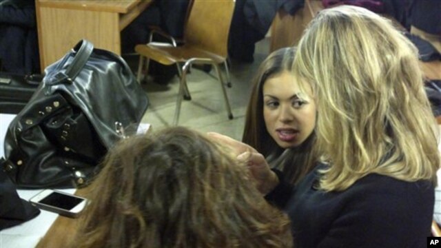 Karima el-Mahroug, center, the Moroccan woman at the center of ex-Prime Minister Silvio Berlusconi's sex-for-hire trial, Milan, Jan. 14, 2013.