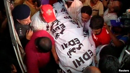 The body of Zahra Shahid Hussain, a senior female politician from cricketer-turned-politician Imran Khan's Tehreek-e-Insaf party, is carried at a hospital in Karachi,  May 18, 2013. 