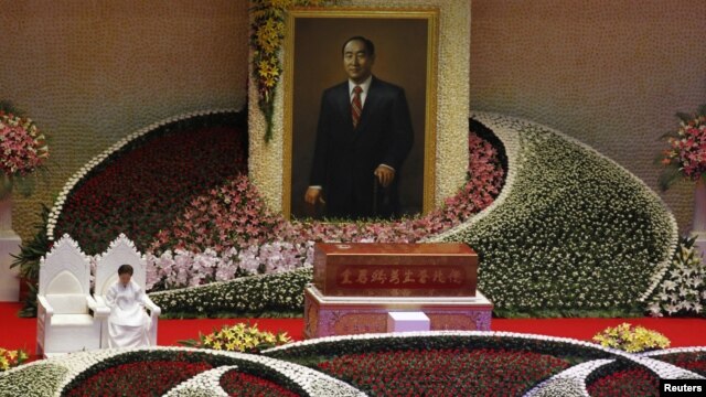 Han Hak-ja, widow of Evangelist Reverend Sun Myung Moon, sits beside the coffin of Moon during a funeral service at the CheongShim Peace World Center in Gapyeong, South Korea, September 15, 2012.