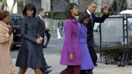President Barack Obama, waves as he walks with his daughters Sasha and Malia, first lady Michelle Obama and mother-in-law Marian Robinson to St. John's Church in Washington, January 21, 2013, for a church service during the 57th Presidential Inauguration. 