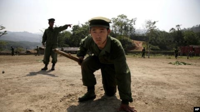 In this photo taken April 17, 2010, recruits of the Kachin Independence Army, one of Myanmar's largest armed ethnic groups, go through battle drills at a training camp near Laiza in Burma.