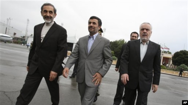 Iranian President Mahmoud Ahmadinejad, center, makes his way during a departure ceremony for him as he leaves the country for Turkey to attend an international conference in Tehran, Iran, May 9, 2011.