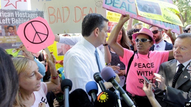 Sen. Ted Cruz, R-Texas, center, talks to a Code Pink member after the antiwar group interrupted his speech during a demonstration in Washington against the proposed Iran nuclear deal because it doesn't address Americans held in Iran, July 23, 2015.