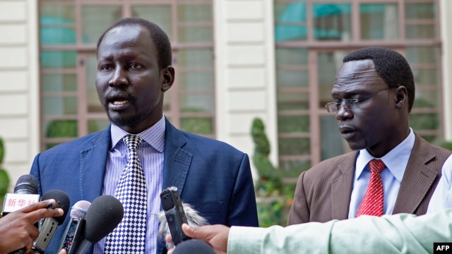 FILE - Lul Ruai Koang (L), the military spokesperson for the Sudan People's Liberation Army (SPLA) and James Gatdet Dak, spokesperson for opposition leader Riek Machar (R), give a statement to the press in Addis Ababa on May 9, 2014. 