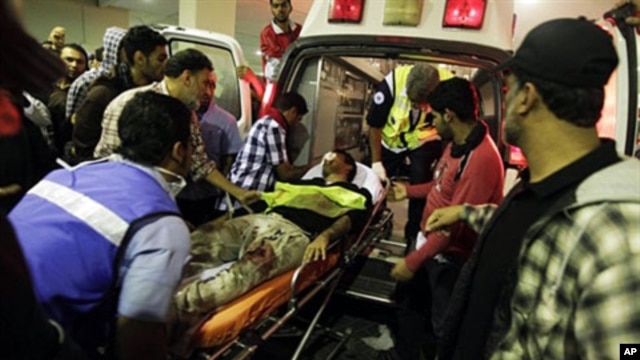A wounded Shi'ite Bahraini demonstrator is taken to a hospital in Manama after being assaulted by riot police on February 17, 2011