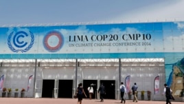 People walk at the venue of the U.N. Climate Change Conference COP 20 in Lima, Peru, Dec. 4, 2014.