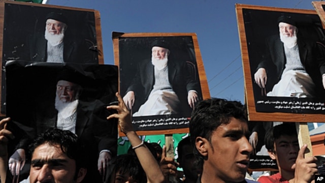 Supporters of the slain former Afghan president Burhanuddin Rabbani shout slogans and hold up his portrait during a protest against the Taliban and Pakistan in Kabul, September 27, 2011.