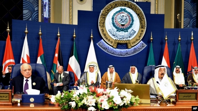 Emir of Kuwait, Sheikh Sabah al-Ahmad al-Sabah, right, and Secretary-General of the League of Arab States, Nabil El Araby, left, attend the closing session of the Arab League Summit at Bayan Palace, Kuwait, March 26, 2014.