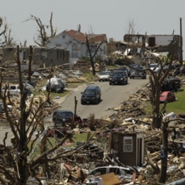 A motorcade carrying President Obama passes through a devastated Joplin, Mo., neighborhood Sunday, May 29, 2011.