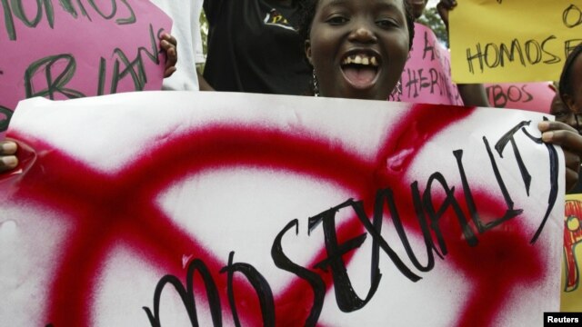 Members of religious groups campaigning against homosexuality hold placards during a rally in Kampala, Uganda, August 21, 2007.