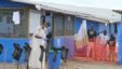 FILE - Boys stand in the "red zone" where they are being treated for Ebola at the Bong County ebola treatment unit about 200 km east of Monrovia, Liberia, Oct. 28, 2014. 