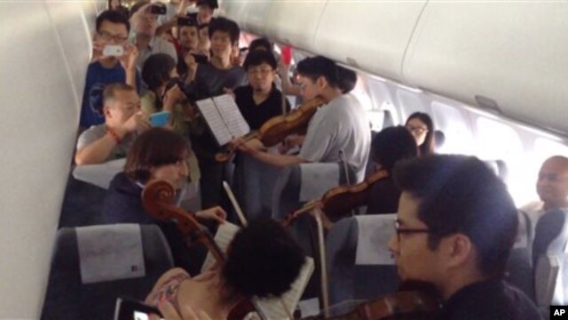 Members of the Philadelphia Orchestra performed on an airplane during a flight delay in Beijing in June.