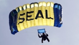 A U.S. Navy SEAL, who is a member of the Navy parachute team 'Leap Frogs', takes part in a demonstration of combat skills at the National Navy UDT-SEAL Museum in Fort Pierce, Florida, November 11, 2011. 