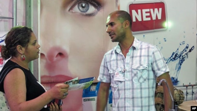 Wissem Abdennadher speaks to a potential customer at the Sfax business fair