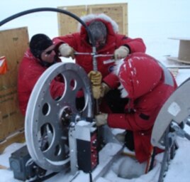 Near U.S. Antarctic McMurdo station scientists practice lowering the ocean profiler down a hole into the ocean beneath the ice.