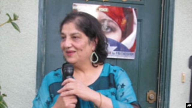 Samina Sundas, founder of American Muslim Voice, welcomes guests to an iftar meal.