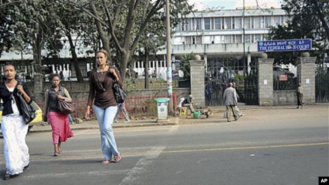 Pedestrians walk past the Federal High Court building housing a terror trial against two Swedish journalists, Johan Persson and Martin Schibbye, in Addis Ababa, Ethiopia, November 1, 2011.