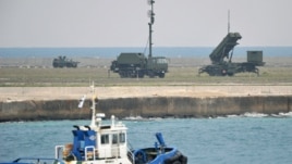 A Patriot Advanced Capability-3 missiles unit (R) is seen as a boat sails past in Ishigaki on Japan's southern island of Ishigaki Island, Okinawa prefecture, December 10, 2012.
