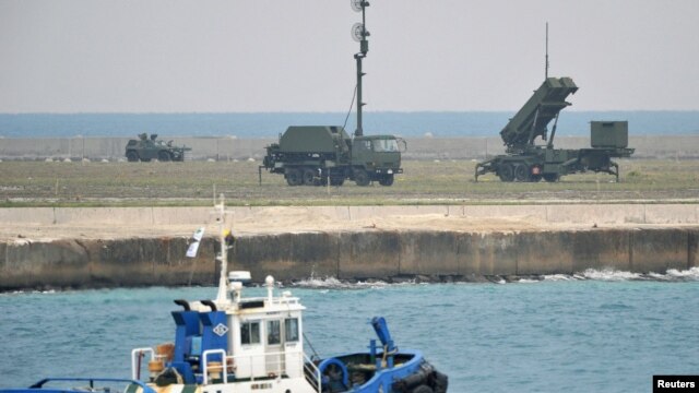 A Patriot Advanced Capability-3 missiles unit (R) is seen as a boat sails past in Ishigaki on Japan's southern island of Ishigaki Island, Okinawa prefecture, December 10, 2012.