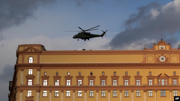 FILE - A Russian military Mi-35 helicopter takes off from the building of Russia's Federal Security Service, the successor agency of the Soviet-era KGB, in Lubyanskaya Square in Moscow, Russia, Feb. 26, 2016.