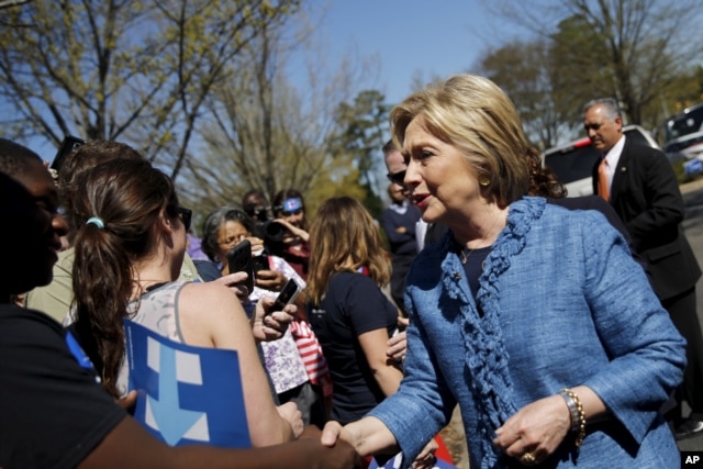 FILE - Democratic U.S. Presidential candidate Hillary Clinton talks to supporters during campaign stop outside of a polling station in Raleigh, North Carolina, March 15, 2016.
