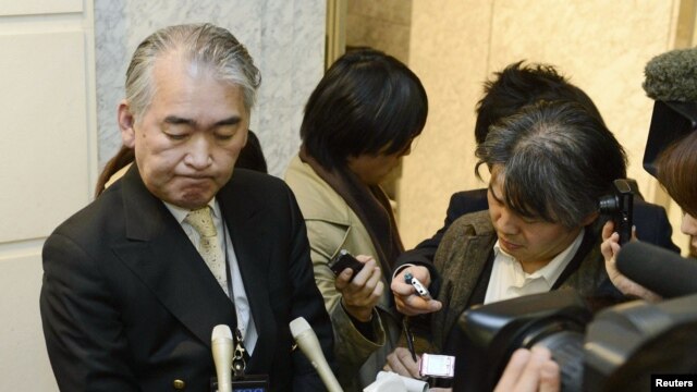 A Public Relations staff of JGC Corp answers reporters at its headquarters in Yokohama, in this photo taken by Kyodo, January 16, 2013.