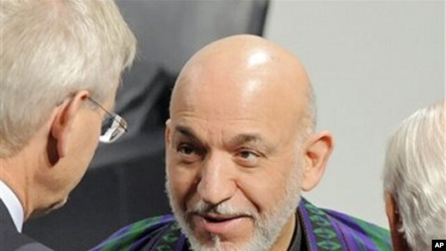 Afghan President Hamid Karzai talks with delegates during the International Conference on Security Policy in Munich, southern Germany, February 6, 2011.