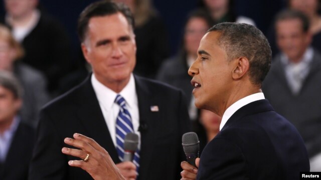 U.S. President Barack Obama (R) speaks as Republican presidential nominee Mitt Romney (L) listens during the second U.S. presidential debate in Hempstead, New York, October 16, 2012.  