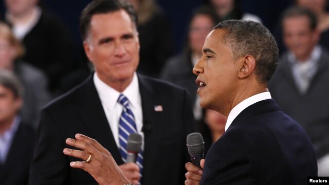 U.S. President Barack Obama (R) speaks as Republican presidential nominee Mitt Romney (L) listens during the second U.S. presidential debate in Hempstead, New York, October 16, 2012.  