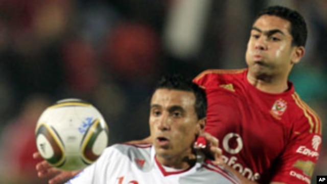El Zamalek's Mohamed Abdel-Shafy (L) fights for the ball with Al-Ahly's Ahmed Fathy during their Egyptian Premier League derby soccer match at Cairo Stadium, (File)
