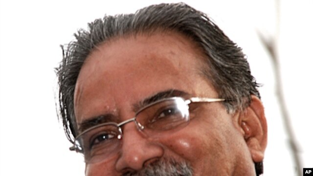Maoist chairman Pushpa Kamal Dahal, aka Prachanda, looking down at cheering supporters as he rides around Kathmandu's Ring Road, 4 Apr 2010