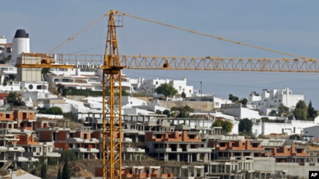 A crane is seen over an abandoned tourist resort construction in Gale on the southern Portuguese province of Algarve, March 6, 2012.