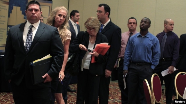 People wait in line to meet with recruiters during a job fair in Melville, New York, July 19, 2012.