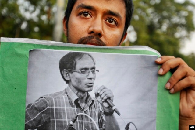 A student holds a portrait of a University Professor A.F.M. Rezaul Karim Siddique during a protest against the killing in Dhaka, Bangladesh, April 29, 2016.