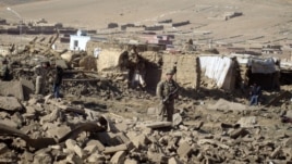 A U.S. soldier stands guard at the site of suicide attack in Wardak Province of Kabul Afghanistan, Friday, Nov, 23, 2012. 