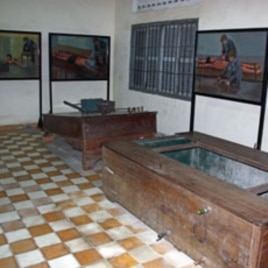 Paintings by human rights icon and artists Vann Nath depicting how torture devices were used hang on the walls of Tuol Sleng Prison in Phnom Penh, Cambodia, June 2011.