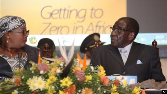 Zimbabwean Deputy Prime Minister Khupe, left, chats with President Mugabe at a women's empowerment event, Harare, May 24,2012.