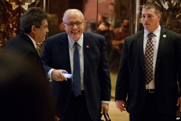 Former New York Mayor Rudy Giuliani, center, smiles as he leaves Trump Tower, Nov. 11, 2016, in New York.