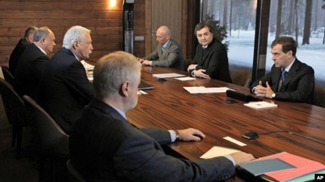 Russian President Dmitry Medvedev, right, speaks at his meeting with leaders of parties that won seats in the State Duma, in the Gorki residence outside Moscow, December 13, 2011.