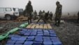 Anti-narcotics police arrange seized packages of cocaine before burning them in La Rinconada on the outskirts of La Paz, Bolivia, 