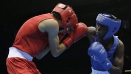 Kenya's Benson Njangiru fights Egypt's Hesham Abdelaal, left, in boxing match at 2012 Summer Olympics July 30, 2012.