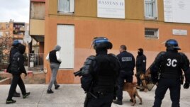 French policemen participate in an operation to fight against narcotics and weapons proliferation at Bassens estate in the northern area of Marseille, southern France, January 12, 2012.