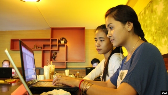 University students from the Royal University of Phnom Penh check the Internet at a coffee shop along the city's Russian Federation Boulevard, Phnom Penh, Cambodia, file photo.