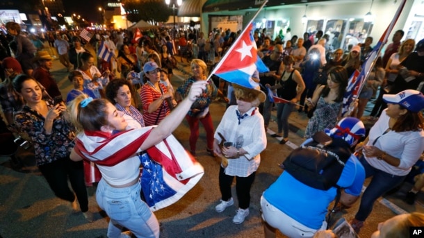 Members of the Cuban community dance in the street as they react to the death of Fidel Castro in front of the Versailles Restaurant in the Little Havana neighborhood of Miami, Nov. 26, 2016.