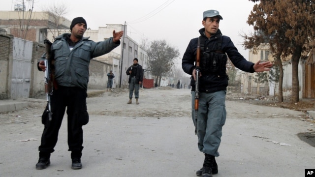 Afghan policemen stand guard near the scene where Afghanistan's Intelligence Chief Asadullah Khalid was wounded in an assassination attempt in Kabul, Afghanistan, December 6, 2012.